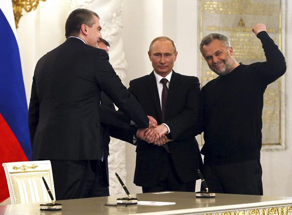 Russian President Putin, Crimea's PM Aksyonov, Crimean parliamentary speaker Konstantinov and Sevastopol Mayor Chaliy shake hands after a signing ceremony in Moscow