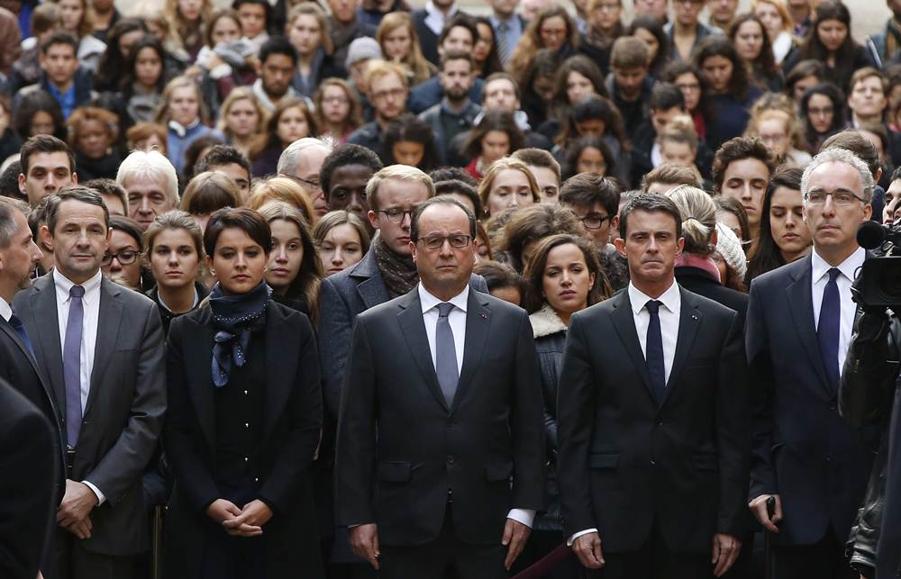 French President Francois Hollande observes a minute of silence at the Sorbonne University in Paris to pay tribute to victims of Friday's Paris attacks