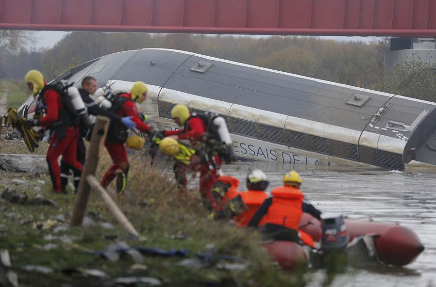 Rescue workers search the wreckage of a test TGV train that derailed and crashed in a canal outside Eckwersheim near Strasbourg
