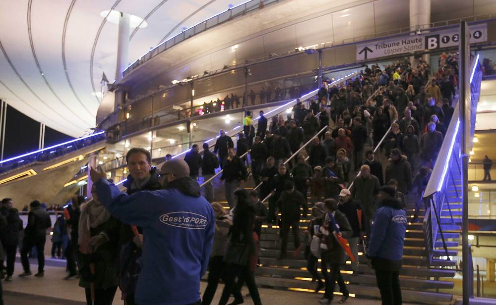 Crowds leave the Stade de France soccer stadium where explosions were reported during the France vs German friendly match