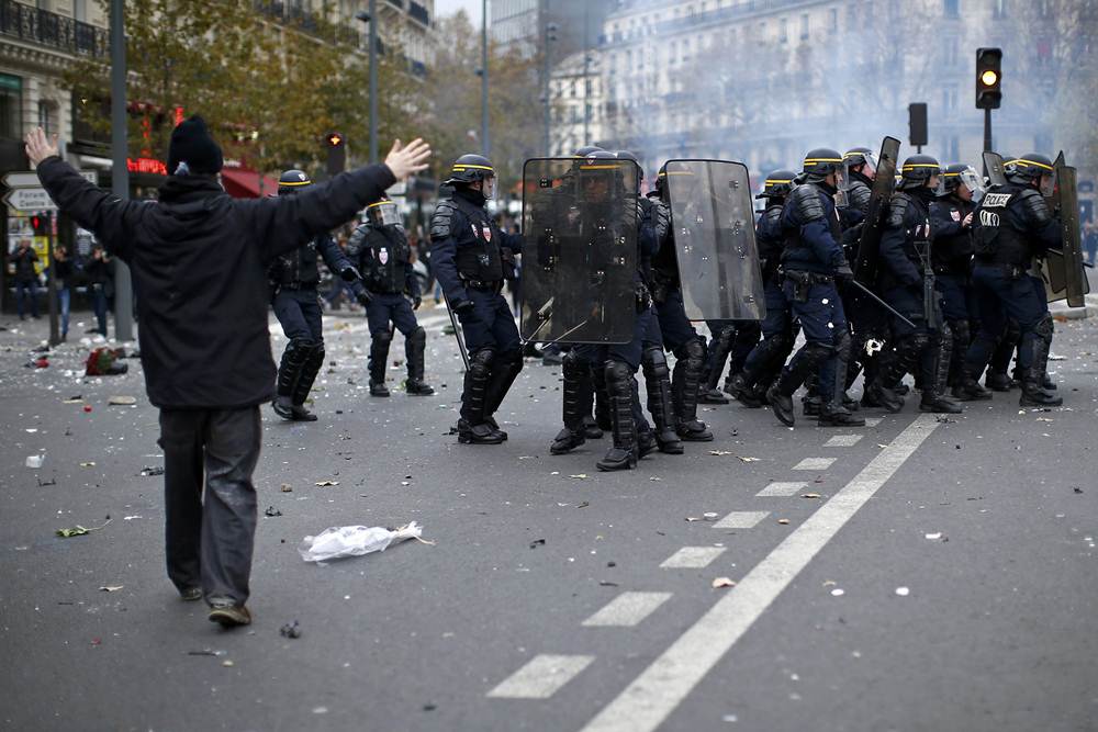 An environmentalist reacts during clashes with French CRS riot police after the cancellation of a planned climate march following shootings in the French capital, ahead of the World Climate Change Conference 2015 (COP21), in Paris