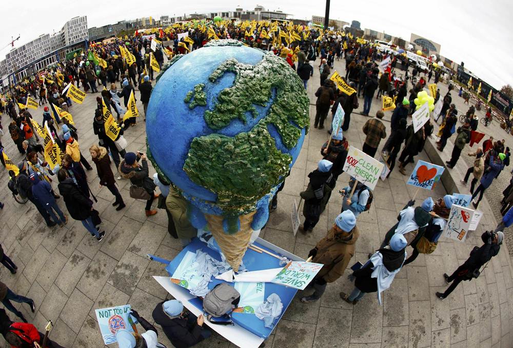 Protesters demonstrate during a rally held the day before the start of the Paris Climate Change Summit in Berlin