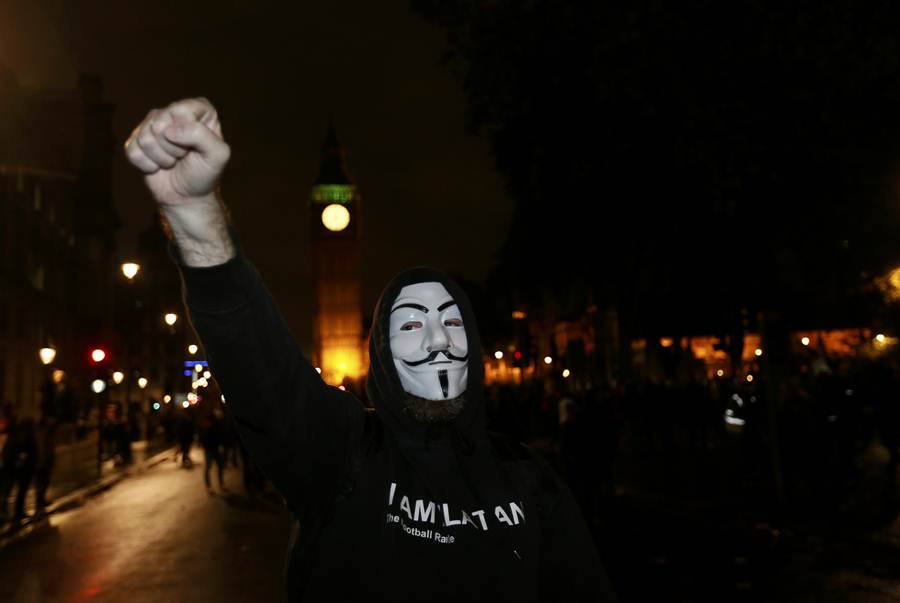A supporter of the activist group Anonymous gestures during a protest in London