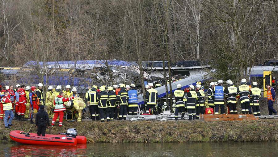 Members of emergency services stand at the site of the two crashed trains near Bad Aibling