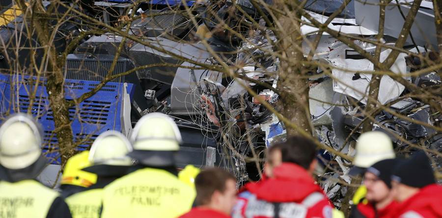 Members of emergency services work at the site of the two crashed trains near Bad Aibling